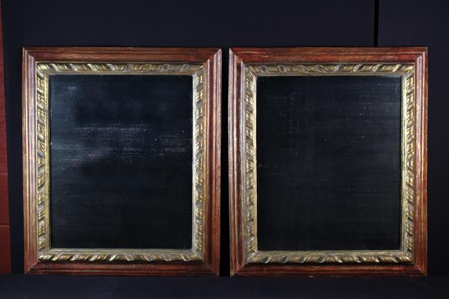 A Pair of 18th Century Italian Wall Mirrors of rectangular form set in painted frames carved with