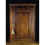 A Fine Late 18th Century Oak Hanging Corner Cupboard with raised mahogany banding and central conch