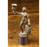 A Small 16th Century Bronze Alloy Figural Taper Stick cast in the form of a naked man with heraldic