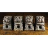 A Set of Four Wooden Ornamental Furniture Blocks carved in the form of renaissance lions' heads