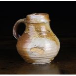 A Small 16th Century Saltglazed Stoneware Baluster Jug with ribbed body, 4¼ in (11 cm) in height.