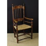 A Provincial 19th Century Rush-seat Spindle-backed Armchair.