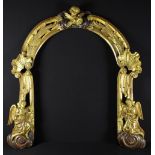 An 18th Century Open Giltwood Arch carved with swept bundles of reeds having bold shell crested