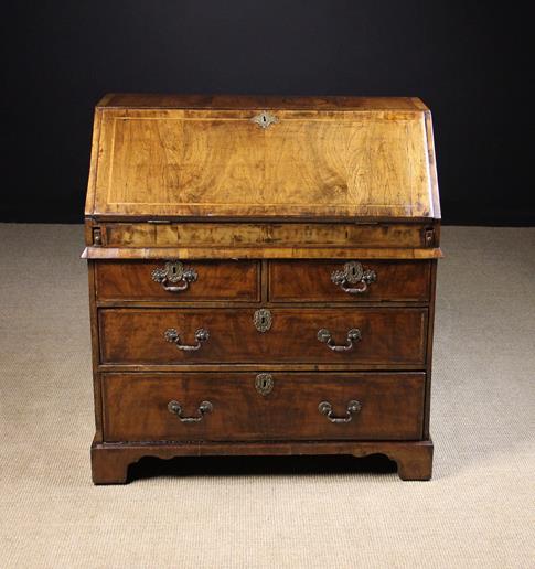 An 18th Century Walnut Bureau inlaid with feather banding and having cross-banded borders.