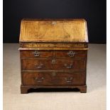 An 18th Century Walnut Bureau inlaid with feather banding and having cross-banded borders.