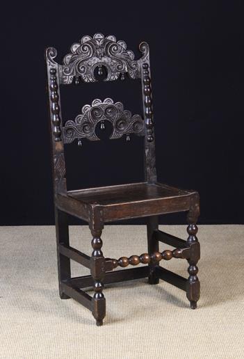 A 17th Century Joined Oak Back-stool attributed to Derbyshire.