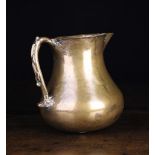 A Medieval Bronze Round Bottomed Jug with inset spout and scroll handle, 6½ ins (16.