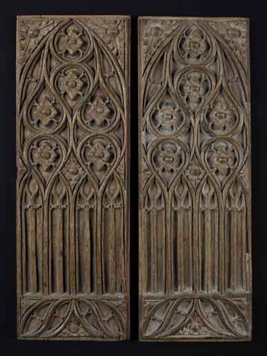 A Pair of 16th Century Dry Oak Panels carved with Gothic tracery, 19 in x 6½ in (48 cm x 16.5 cm).