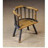 A 19th Century Ash Country Child's Windsor Armchair with residual paint.