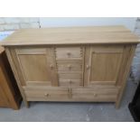 A John Lewis oak sideboard with five drawers and two cupboard doors - Width 120cm x Depth 50cm x