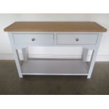 A Bramblecrest two drawer side table with a oak top and painted base 82 cm tall 120 by 40