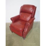 A red leather reclining armchair with studded decoration - Height 105cm x With 87cm