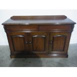 A Victorian style mahogany side cabinet by Sim Beck with two drawers above three doors - Height