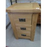 A good quality oak bedside chest with three drawers - Height 72cm x Width 45cm