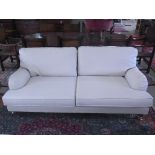 A modern three seater sofa - Length 200cm - on turned legs and brass casters