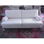 A modern three seater sofa - Length 200cm - on turned legs and brass casters