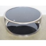 A brushed steel and glass circular designer coffee table - Diameter 91cm