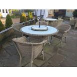 A Bramblecrest Sahara table and four stacking armchairs and a parasol and base - Diameter 130cm