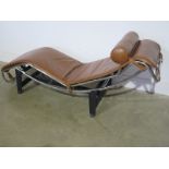 A Le Corbusier style designer chrome and leather chaise lounge