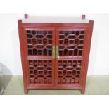 A painted Chinese lacquered red cabinet with two doors - 110cm x 90cm wide