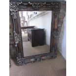 A modern ornate gilt mirror with bevel edge glass - 120cm x 90cm