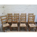 A set fo eight modern ladder back dining chairs with rush seats