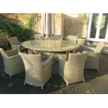 A Bramblecrest Sahara oval table with eight armchairs and a parasol and base - secondhand but in