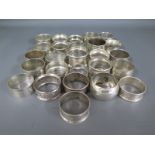 Twenty six silver hallmarked napkin rings, varying design and size, Weight approx.