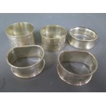 Three silver hallmarked napkin rings and two silver plated