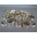 Twenty silver hallmarked napkin rings, varying design and size - Weight approx.