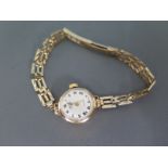 A ladies 9ct yellow gold Rotary wristwatch with Roman numerals to white enamel dial on 9ct gold