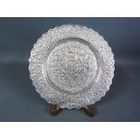 An Indian silver dish embossed decoration of palm trees elephants and animals - Diameter 18cm -