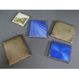 Four silver cigarette cases and a compact,