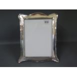 A silver hallmarked photo frame - 21cm x 25cm high,