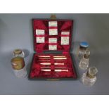 Five scent bottles with silver tops or collars and a sewing set - varying condition