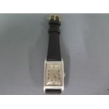 A Cyma steel cased gents wristwatch, rectangular silvered dial with Arabic numerals,