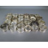 Twenty four silver hallmarked napkin rings, varying design and size - Weight approx.