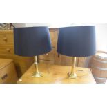 A pair of brass column table lamps standing 62cm high with shades