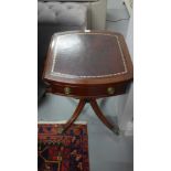 A reproduction oval topped drop leaf occasional table inset top over single drawer raised on