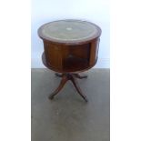 A mahogany effect revolving bookcase with an inset top - Height 66cm x Diameter 51cm