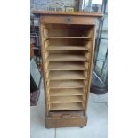An oak tambour fronted cabinet,