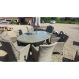 A Bramblecrest oval table with two reclining armchairs and six other armchairs,