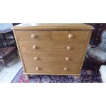 A Victorian stripped pine chest of 2 short over 3 long drawers raised on turned feet - 120cm x 52cm