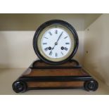 A 19th century walnut and ebony French mantle clock with 8 day movement strikes on a bell,