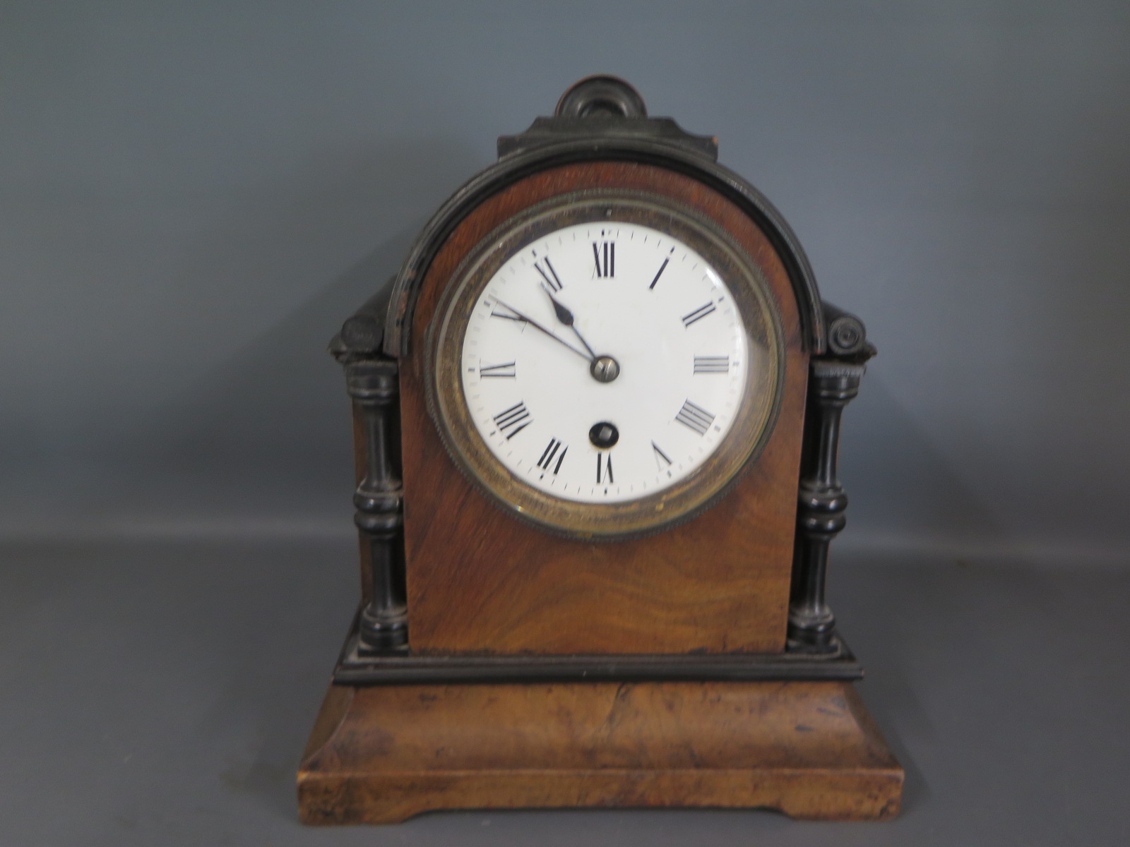 A 19th century walnut and ebonised cased mantle clock, Roman numerals to white enamel dial,