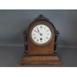 A 19th century walnut and ebonised cased mantle clock, Roman numerals to white enamel dial,