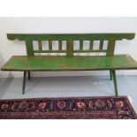 An antique pine bench with back,