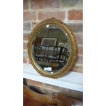 An oval gilt framed bevel-edge wall mirror - circa 1930