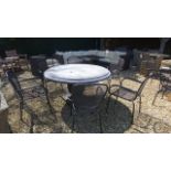 A Bramblecrest round stone table with six chairs and cushions