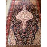 A hand knotted woollen rug - 2.30m x 1.